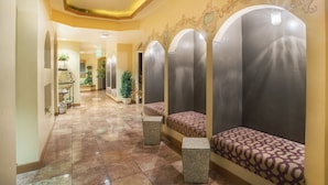 A hallway with a tiled floor, benches with patterned upholstery, and decorative wall elements. - Family Getaway~Pool, Tubing, Skiing, & Ice Castles Villa 1063 (Midway)