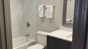 Bathtub, towels, soap, toilet paper