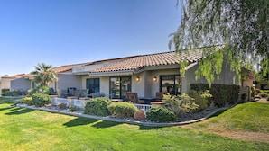 A residential building with a patio area, outdoor seating, and a well-maintained lawn. - Updated Palm Desert Escape w/ Resort Amenities! (Palm Desert)