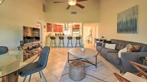 A spacious living area with a dining table, chairs, a sofa, and a ceiling fan. - Updated Palm Desert Escape w/ Resort Amenities! (Palm Desert)