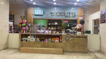A specialty store with a variety of hats and accessories displayed in the window.