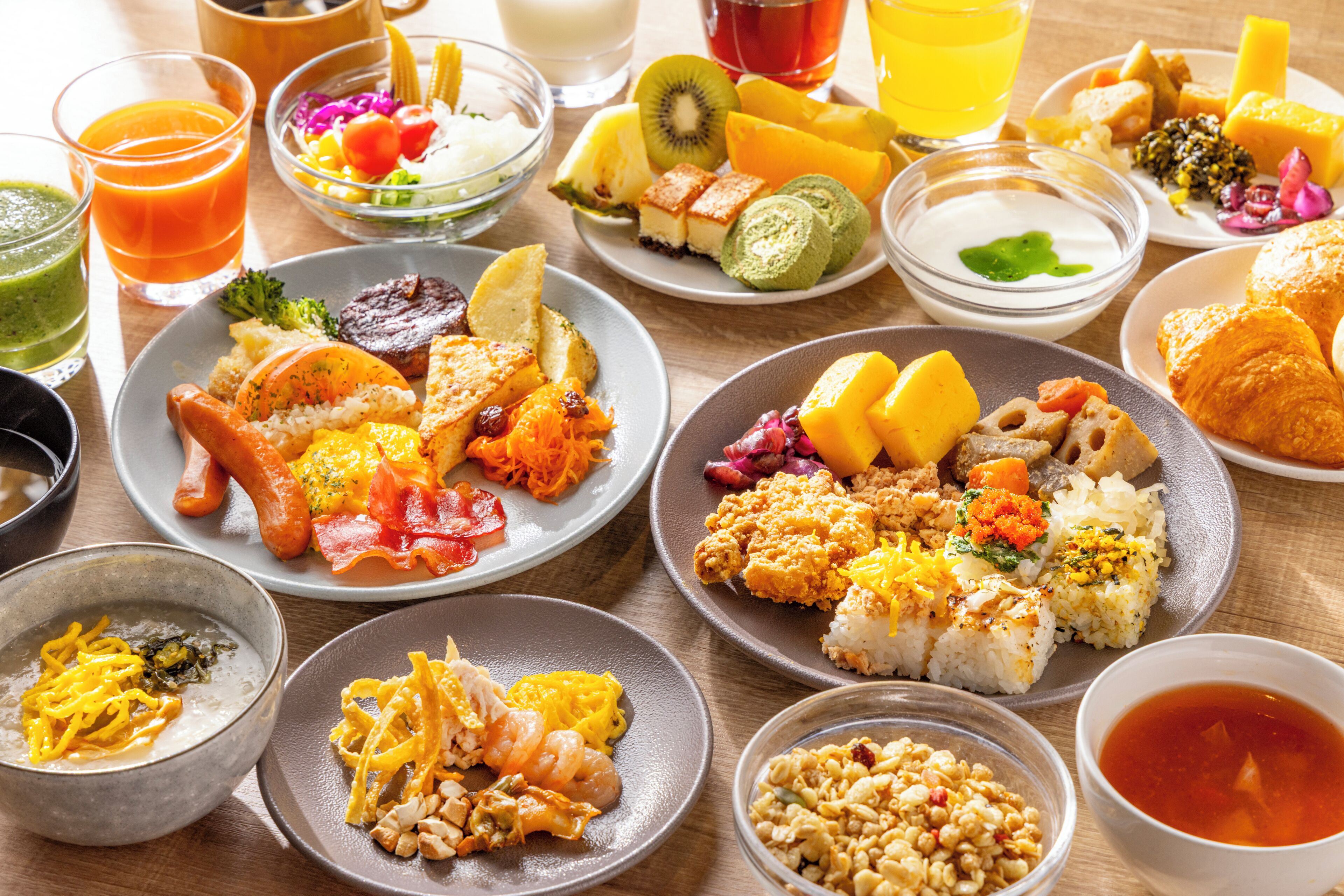 A variety of dishes including sushi, sashimi, and a selection of fruits and vegetables.