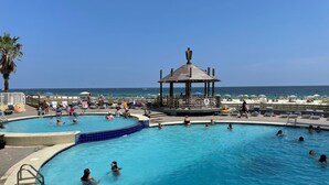 A swimming pool with a gazebo and beach view. - Wraparound Balcony provides Gorgeous Gulf Views from Every Room (Orange Beach)