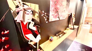 A room with a large decorative figure, a wooden table with small items, and a painting of cherry blossoms. - Eternity APARTMENT HOTEL SHINAGAWA (Tokyo)