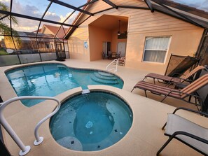 A heated pool, sun loungers