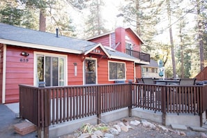 A red cabin with a balcony, a deck, and a number 839 sign. - Close to Bear Mountain & Golf Course! Hot Tub! Fenced Yard! Foosball! (Big Bear Lake)