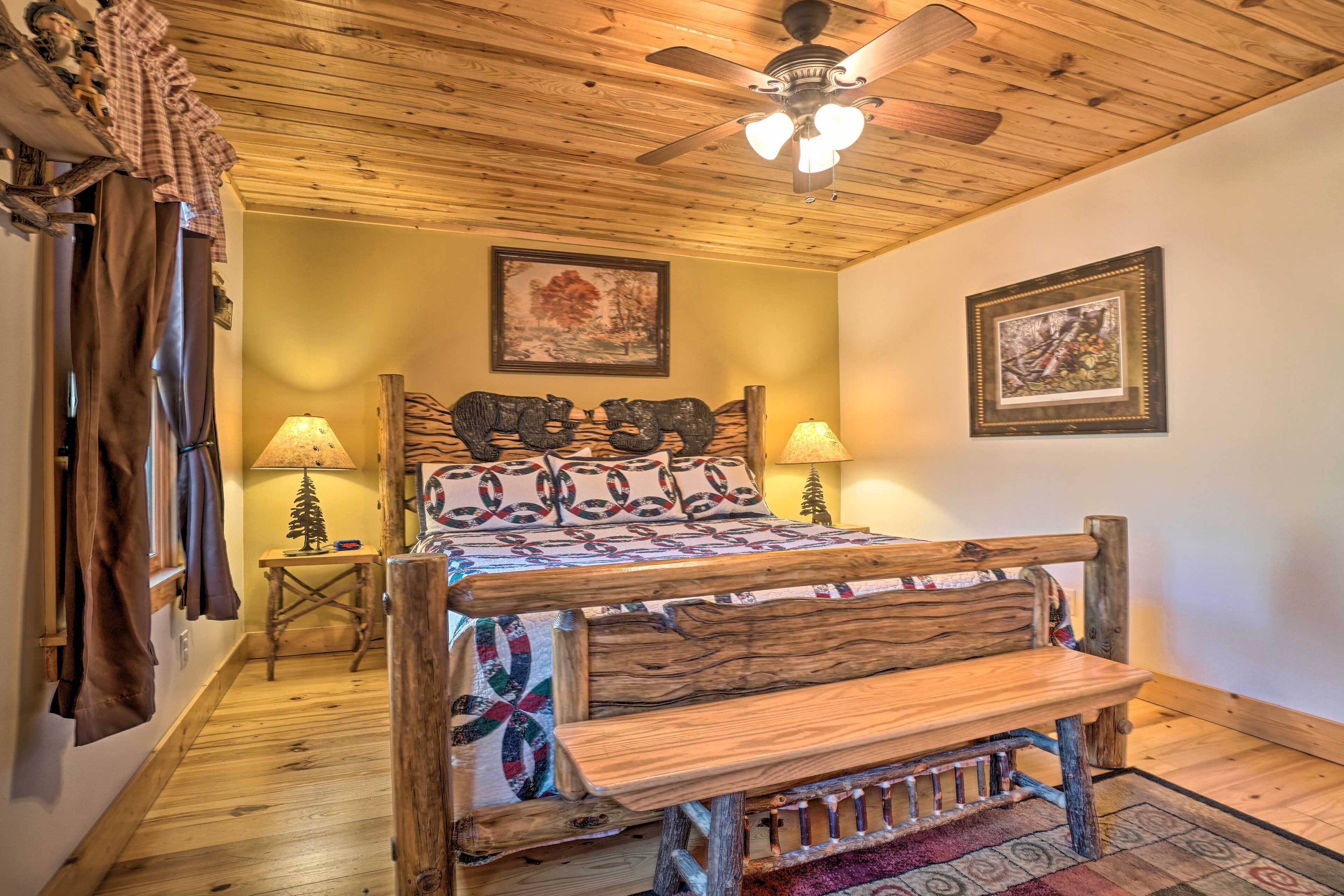 A cozy bedroom with a wooden bed, two bedside lamps, a ceiling fan, and a rustic decor theme.