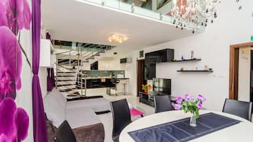 Apartment (Four Bedroom Duplex Apartment) | Living room | 25-inch flat-screen TV with cable channels, TV, DVD player