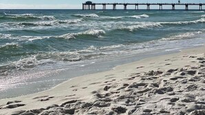 A beach with a pier extending into the ocean. - Destin West G204 — Gulfside 2BR + Bunk Room, Sleeps 8 (Fort Walton Beach)