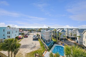A resort with multiple buildings, a swimming pool, and a parking area. - 8BR Beach Oasis w/ Pool & Rooftop (Isle of Palms)