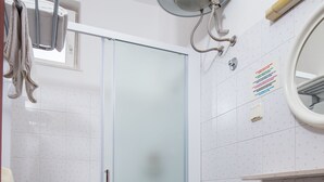 A bathroom with a glass shower enclosure, a white toilet, and a sink with a mirror above it. - Villa Konalić - Double or Twin Room with Balcony and Sea View 1 (Mokosica)