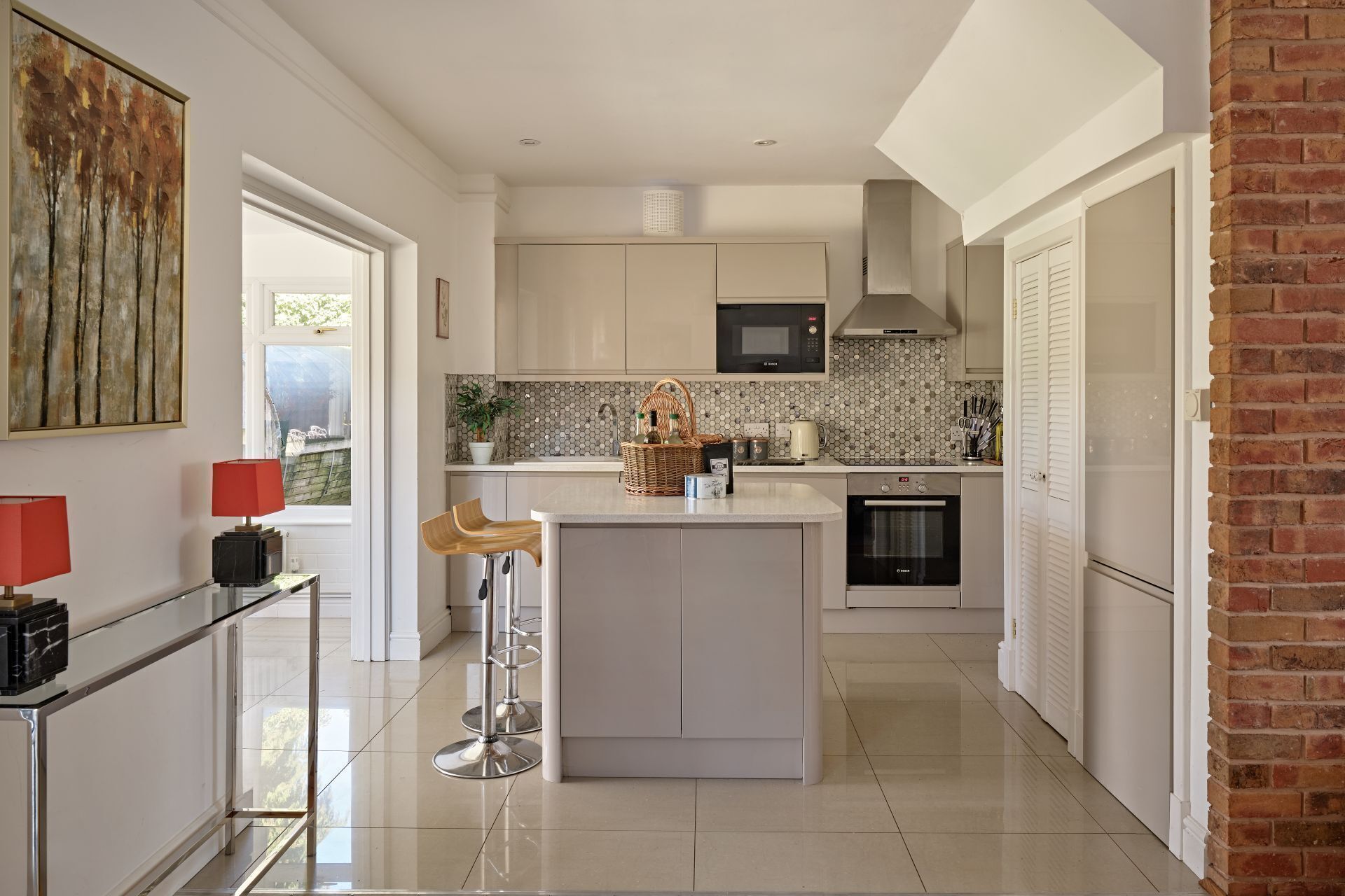 A modern kitchen with a central island, a microwave, and a dishwasher.