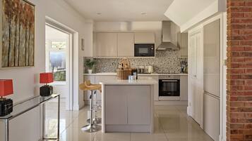 A modern kitchen with a central island, a microwave, and a dishwasher.