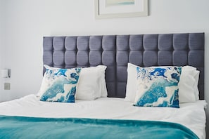 Restful retreat with a tufted headboard and plush bedding.