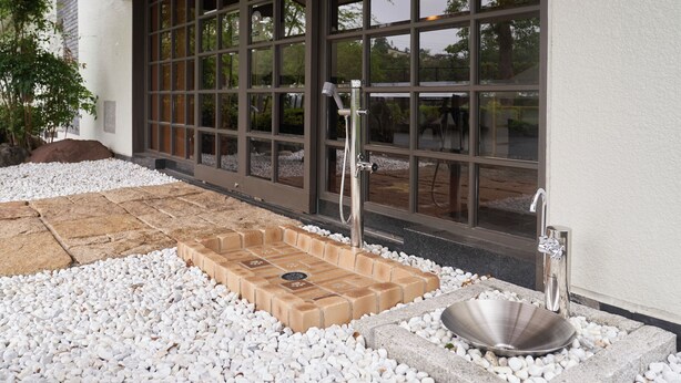 A spa area with a stone basin, a shower, and a tiled floor. -  Livemax Resort Izukogen ANNEX (Ito)