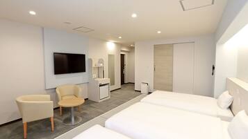 A modern hotel room with two beds, a TV, a desk, a chair, and a wardrobe.