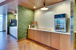 Una cocina moderna con una cafetera, un refrigerador y una encimera con alimentos.
