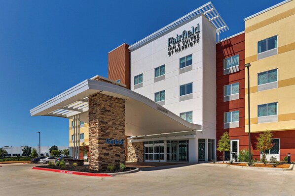 Un hotel Fairfield Inn & Suites by Marriott con un diseño moderno, que presenta una entrada destacada y un estacionamiento.