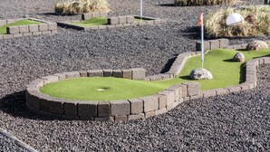 A miniature golf course with green grass, stone borders, and flags. - 1 bedroom stunning home in Hvide Sande (Hvide Sande)