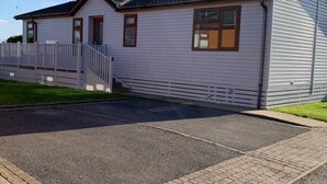 A single-story building with a flat roof, a front porch, and a small staircase leading to the entrance.