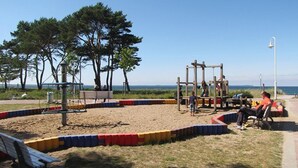A playground with a swing set, a seesaw, and a bench. - Very spacious thatched house with lots of comfort on a large plot in a peripheral location (Glowe)