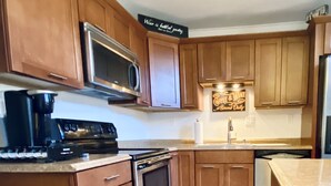 A kitchen with wooden cabinets, stainless steel appliances, and a countertop.