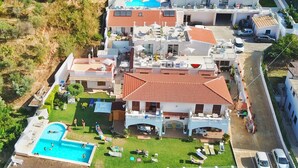 A large, multi-story residential building with a swimming pool, multiple balconies, and a well-maintained garden. - Appartamenti Borgo Panoramico N.8 (Tropea)