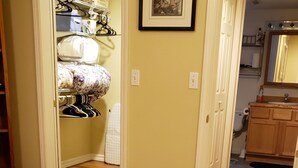 A bedroom with a bed, a wardrobe, and a bathroom visible through an open door. - Property near Pioneer Park, Chena River, and the Carlson Center. Sleeps 4 (Fairbanks)