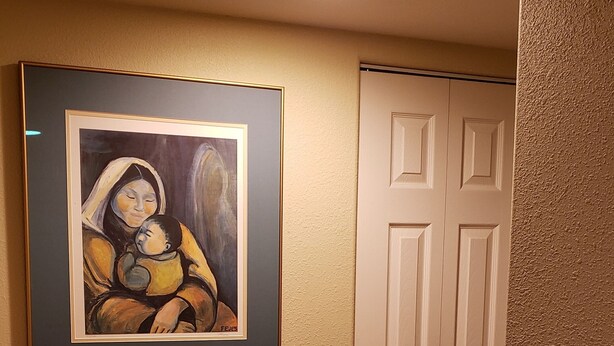 A hallway with a framed painting on the wall, a white door, and wooden flooring. - Property near Pioneer Park, Chena River, and the Carlson Center. Sleeps 4 (Fairbanks)