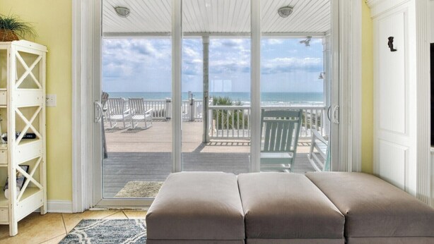 A room with a sliding glass door leading to a balcony with beach views. - Heaven Can Wait - Oceanfront w/ Heated Pool and Sooo Much More! (Garden City Beach)
