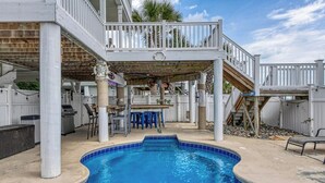 A swimming pool with a deck area, outdoor bar, and seating. - Heaven Can Wait - Oceanfront w/ Heated Pool and Sooo Much More! (Garden City Beach)