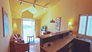 A compact living space with a kitchenette, a dining area, and a sofa.