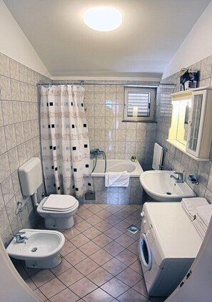 Bathtub, hair dryer, towels