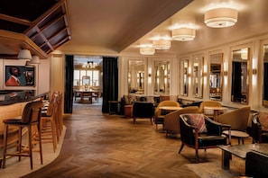 A spacious hotel lobby with a long reception desk, multiple seating areas, and large mirrors on the walls. - Clayton Hotel & Members Club - Cherry Creek, Denver (Denver)