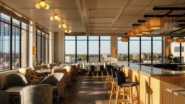 A modern bar area with seating, large windows, and a city view. - Clayton Hotel & Members Club - Cherry Creek, Denver (Denver)