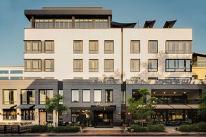 A multi-story hotel with a flat facade, large windows, and outdoor seating areas. - Clayton Hotel & Members Club - Cherry Creek, Denver (Denver)