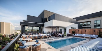 Outdoor pool, sun loungers at Clayton Hotel & Members Club