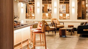 A modern interior with a bar area, seating, and a herringbone wood floor. - Clayton Hotel & Members Club - Cherry Creek, Denver (Denver)