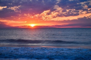 A sunset over the ocean with waves approaching the shore. - 11741 Pasetto Ln #301 (Fort Myers)