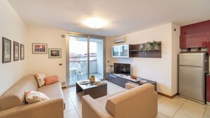 Un apartamento moderno con sala de estar, cocina y balcón.