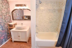 Bathtub, eco-friendly toiletries, hair dryer, towels