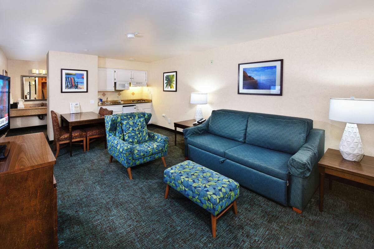 family suite, 2 queens & kitchenette | living area | 27-inch tv with cable channels, dvd player