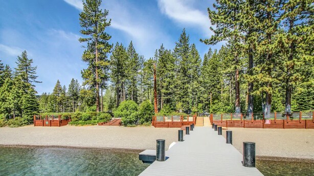 A wooden dock leading to a clear water body, surrounded by dense forest and a clear sky. - Lake Tahoe’s Ultimate Family & Friends Retreat (Olympic Valley)