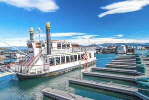 Docked at the marina, this classic riverboat offers a covered deck area perfect for dining or entertainment.