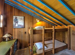 A bunk bed with a ladder, a desk with a lamp, and a painting on the wall. - Quail View - Spacious Sea Ranch Family Lodge (Sea Ranch)