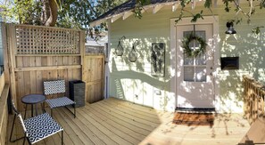 Enjoy a warm welcome on the outdoor deck with a small table and two chairs.