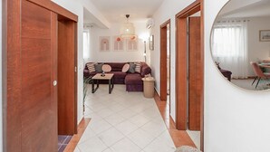 A hallway leading to a living area with a sofa, a small table, and a mirror. - 2 bedroom nice apartment in Rogoznica (Rogoznica)