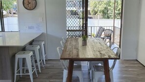 Enjoy meals in this dining area with a long table and comfortable seating for all.
