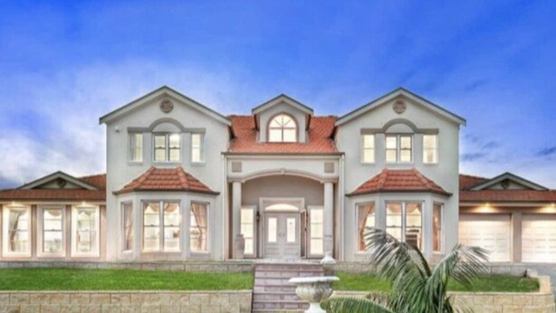 A large, two-story house with a symmetrical facade, a central entrance, and a well-maintained lawn. - In the Hunter Valley and need a place to stay for a big group? Look no further (Bellbird)