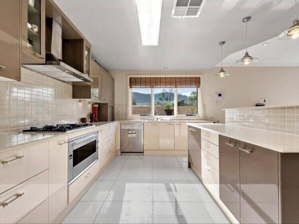 Enjoy cooking in this well-equipped kitchen with a gas stove, sink, and dishwasher.